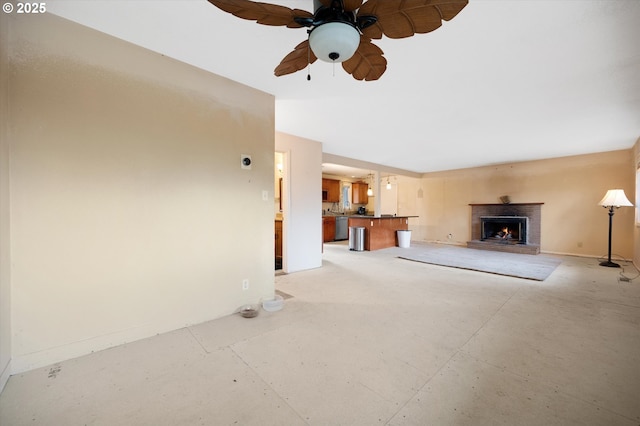 7080 SW Taylors Ferry Rd, Portland, OR 97223 - unfurnished living room featuring a brick fireplace, a ceiling fan, baseboards, and concrete floors