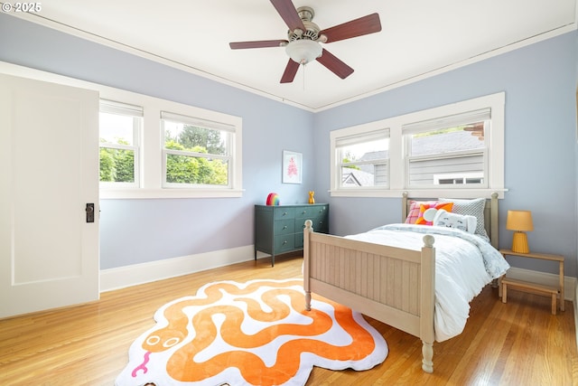 2904 NE 51st Ave, Portland, OR 97213 - bedroom featuring multiple windows, wood finished floors, crown molding, and baseboards