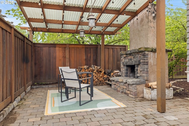 2904 NE 51st Ave, Portland, OR 97213 - fenced backyard with an outdoor stone fireplace and a patio area