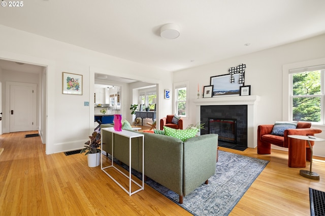 2904 NE 51st Ave, Portland, OR 97213 - living area with a fireplace, light wood-style floors, and plenty of natural light