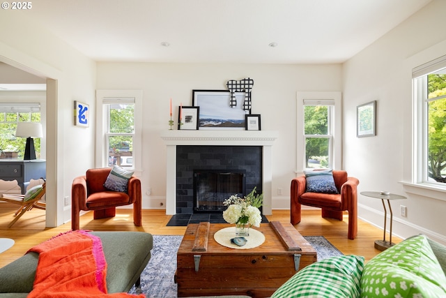2904 NE 51st Ave, Portland, OR 97213 - living room with wood finished floors, a fireplace with flush hearth, and baseboards