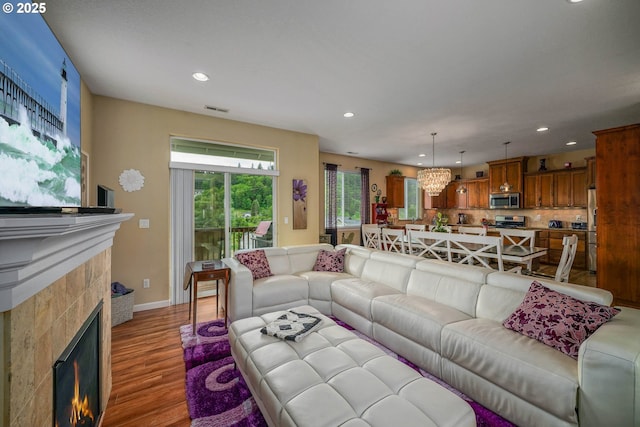 2356 Benjamin Ave, Salem, OR 97304 - living room featuring a lit fireplace, light wood-style floors, recessed lighting, and baseboards