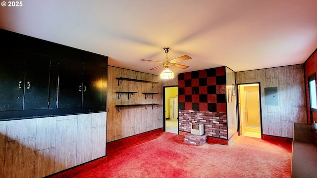 2965 S Myrtle Rd, Myrtle Creek, OR 97457 - unfurnished living room with electric panel, ceiling fan, carpet, and wood walls
