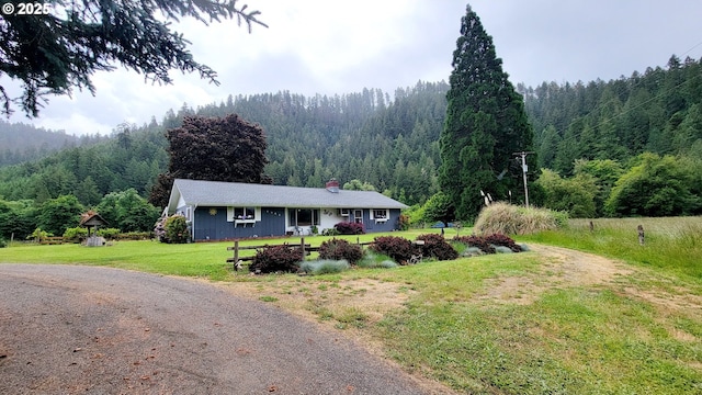 2965 S Myrtle Rd, Myrtle Creek, OR 97457 - single story home with a wooded view, a front lawn, and a chimney