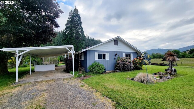 2965 S Myrtle Rd, Myrtle Creek, OR 97457 - view of side of property featuring driveway, a yard, a carport, and a mountain view