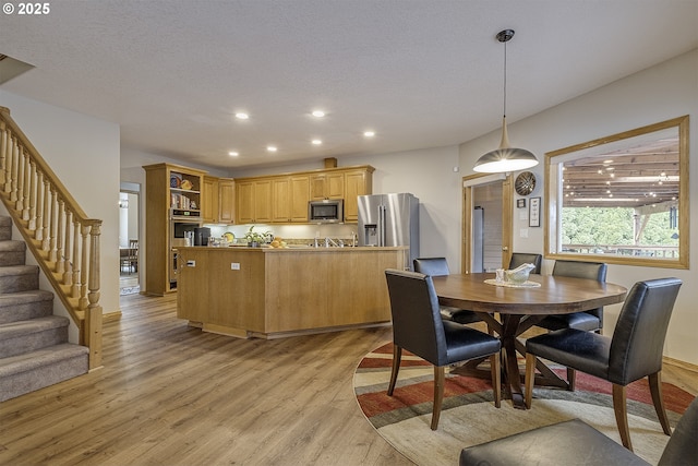 610 NE Sundance Ct, Hillsboro, OR 97124 - dining room featuring light wood-style floors, recessed lighting, and stairway