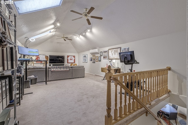 610 NE Sundance Ct, Hillsboro, OR 97124 - carpeted bedroom featuring an AC wall unit, a textured ceiling, vaulted ceiling, track lighting, and baseboards