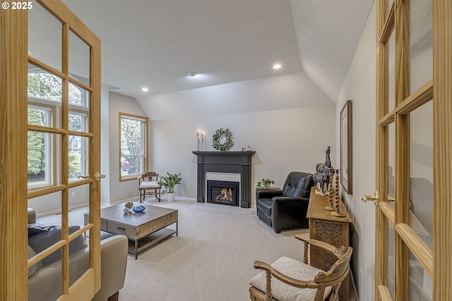 610 NE Sundance Ct, Hillsboro, OR 97124 - living room featuring vaulted ceiling, a textured ceiling, a glass covered fireplace, carpet, and recessed lighting