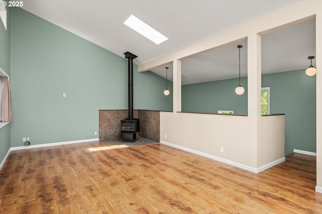32475 Beymer Rd, Eugene, OR 97405 - unfurnished living room featuring a wood stove, wood finished floors, and baseboards