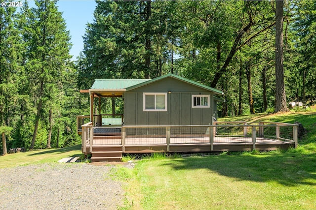 32475 Beymer Rd, Eugene, OR 97405 - view of front facade with board and batten siding, a front yard, and a wooden deck