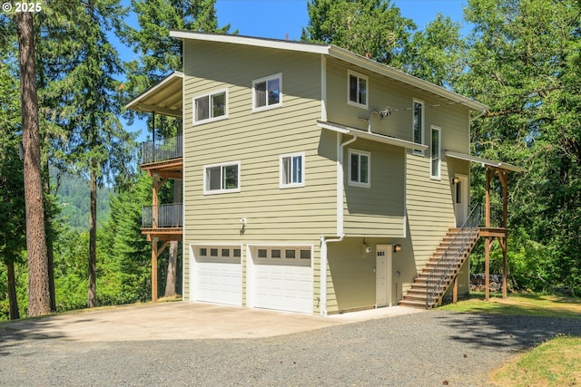 32475 Beymer Rd, Eugene, OR 97405 - view of side of property with driveway, a garage, a balcony, and stairway