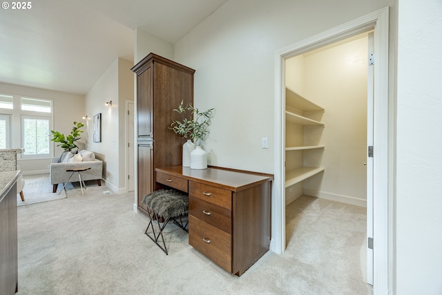 home office featuring light carpet and baseboards