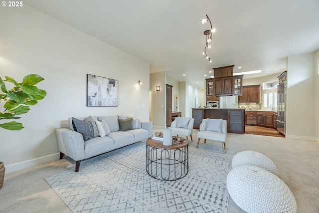 living area with recessed lighting, baseboards, and light colored carpet