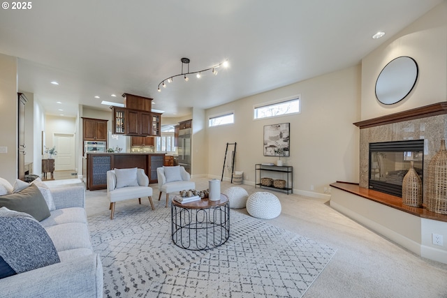 living room featuring recessed lighting, light carpet, baseboards, and a premium fireplace