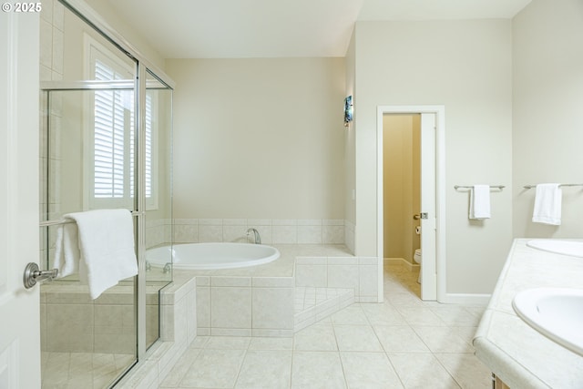 full bathroom with a stall shower, toilet, tile patterned floors, a garden tub, and a sink