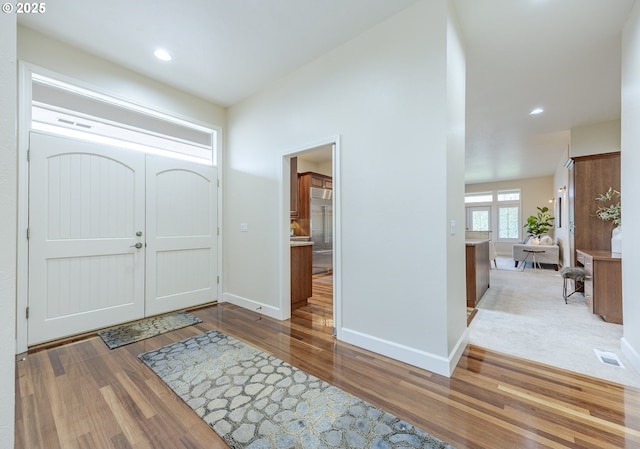 entrance foyer with recessed lighting, wood finished floors, visible vents, and baseboards