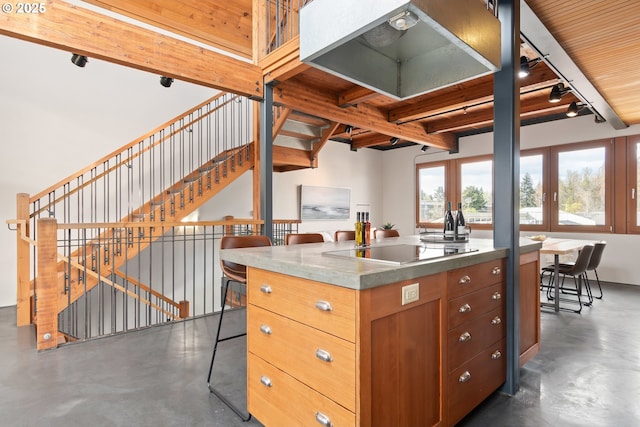 321 Mill St Unit 4, Eugene, OR 97401 - kitchen featuring black electric stovetop, rail lighting, finished concrete flooring, french doors, and beamed ceiling