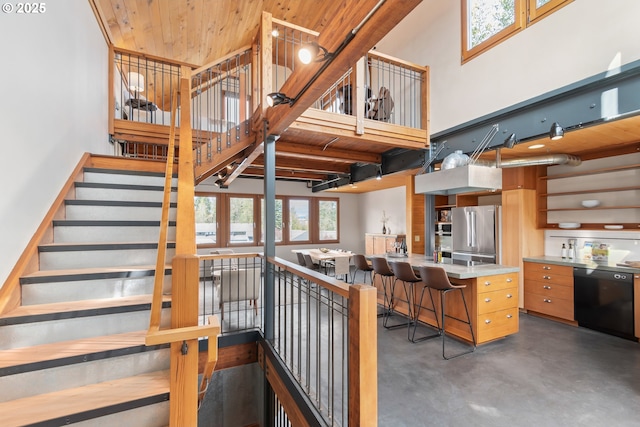 321 Mill St Unit 4, Eugene, OR 97401 - staircase with concrete floors, wooden ceiling, and a towering ceiling