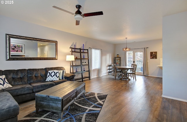 living room featuring hardwood / wood-style flooring and ceiling fan