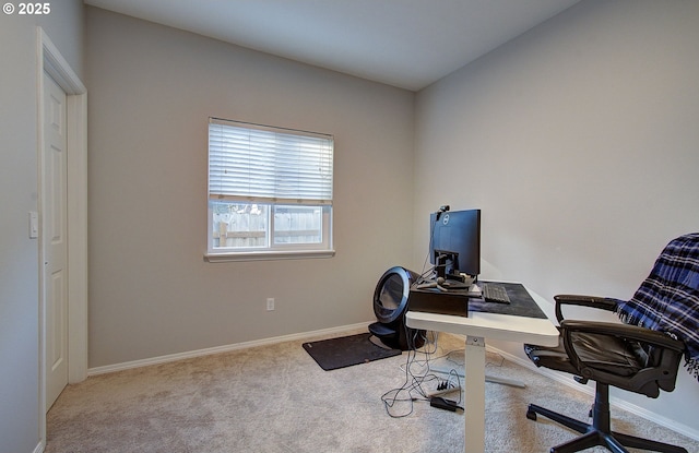 carpeted home office featuring vaulted ceiling