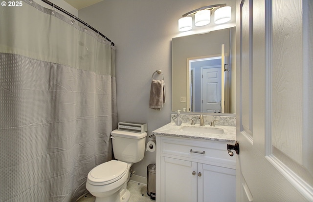 bathroom with vanity, a shower with shower curtain, and toilet