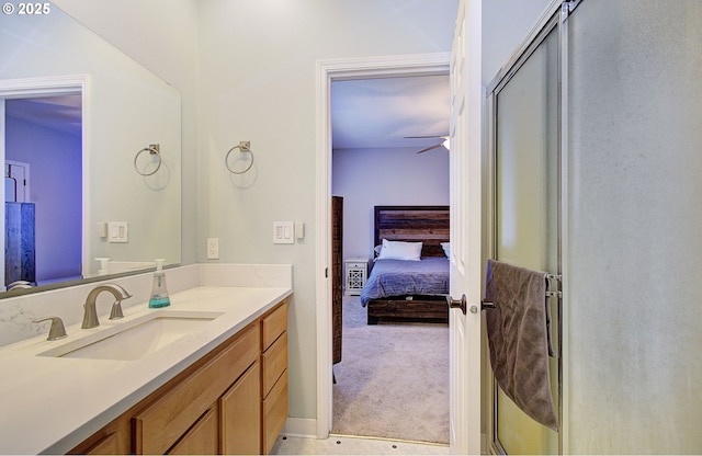 bathroom featuring walk in shower, ceiling fan, and vanity