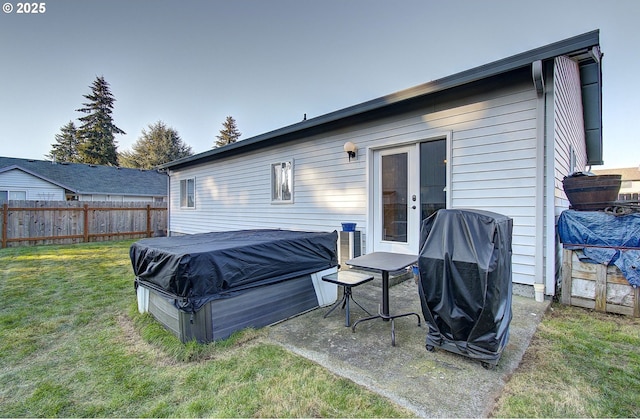 rear view of property featuring a lawn