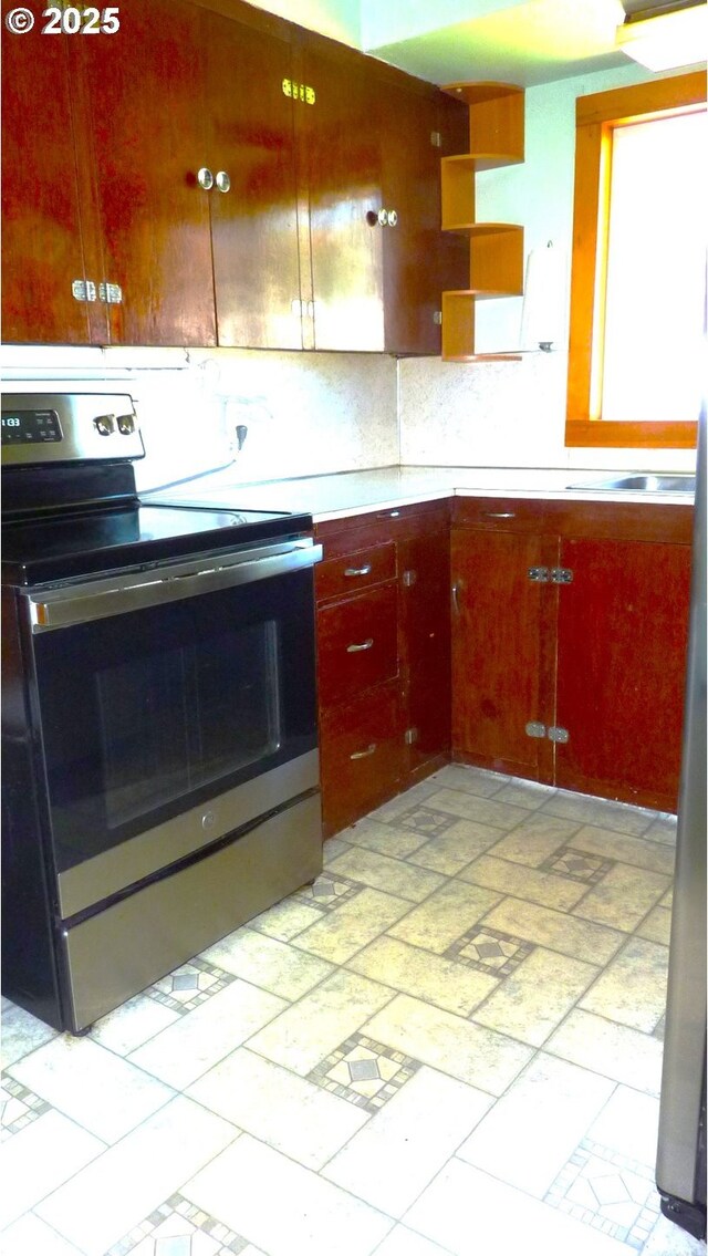 610 Bluff Rd, Klickitat, WA 98628 - kitchen featuring stainless steel range with electric cooktop, light countertops, decorative backsplash, and open shelves