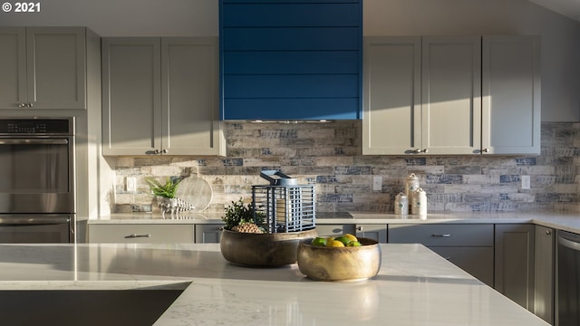 7304 SW Pacific Coast Hwy, Waldport, OR 97394 - kitchen featuring stainless steel appliances, backsplash, light stone countertops, and gray cabinetry