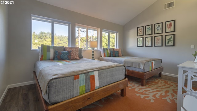 7304 SW Pacific Coast Hwy, Waldport, OR 97394 - bedroom with lofted ceiling, multiple windows, and wood finished floors