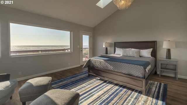 7304 SW Pacific Coast Hwy, Waldport, OR 97394 - bedroom featuring a skylight, lofted ceiling, wood finished floors, and access to exterior