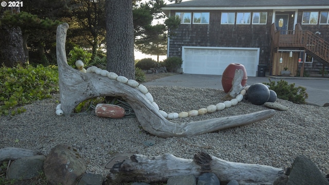 7304 SW Pacific Coast Hwy, Waldport, OR 97394 - view of front of house with a garage, concrete driveway, and stairway