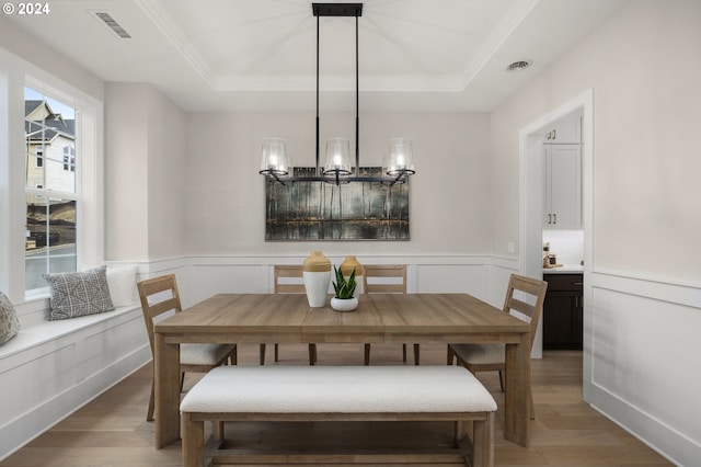 17733 NW Layla Ter Lot 6, Portland, OR 97229 - dining area with light wood-style flooring, a tray ceiling, a decorative wall, ornamental molding, and wainscoting