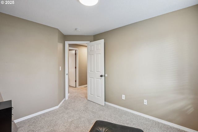 unfurnished bedroom featuring light carpet