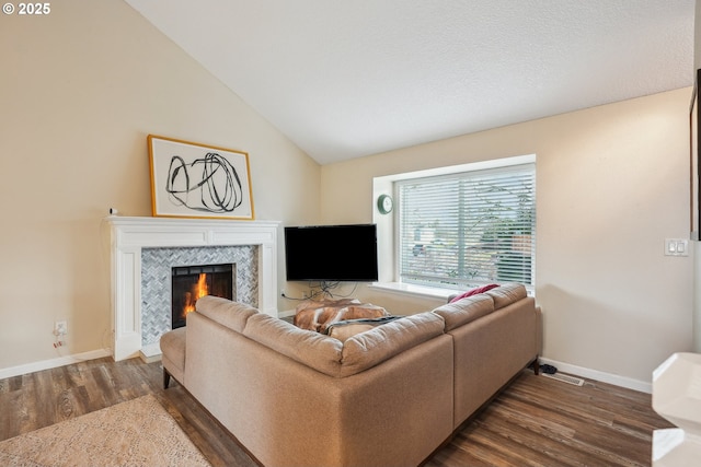 living room with dark hardwood / wood-style floors, a fireplace, and vaulted ceiling