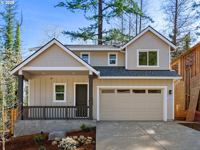view of front of property with roof with shingles, a porch, concrete driveway, and an attached garage