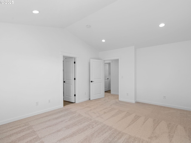 unfurnished bedroom with lofted ceiling, recessed lighting, light carpet, and baseboards