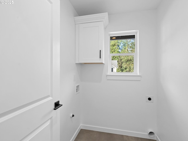 laundry area featuring hookup for an electric dryer, cabinet space, washer hookup, and baseboards