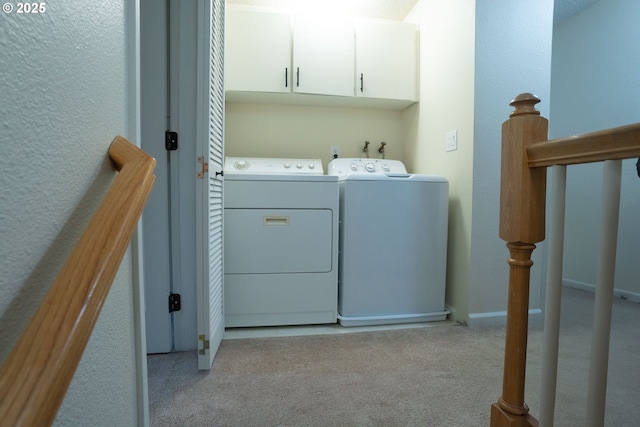 laundry room featuring washing machine and dryer and light carpet