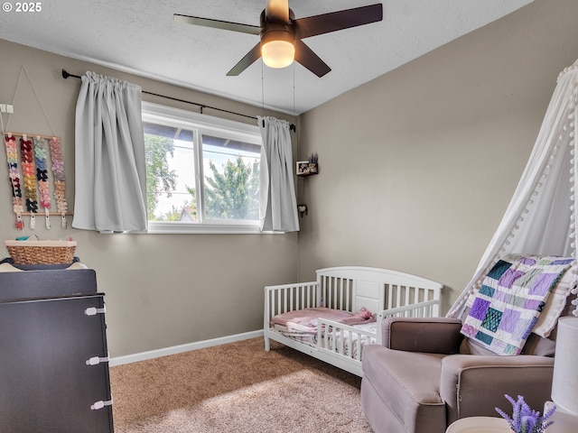 426 NE Hill St, Sheridan, OR 97378 - carpeted bedroom with baseboards, a ceiling fan, and a nursery area