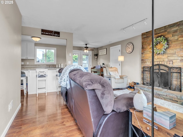 426 NE Hill St, Sheridan, OR 97378 - living area with a ceiling fan, light wood-style flooring, rail lighting, and a large fireplace
