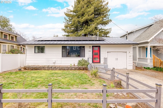 ranch-style house with metal roof, a standing seam roof, and an attached garage