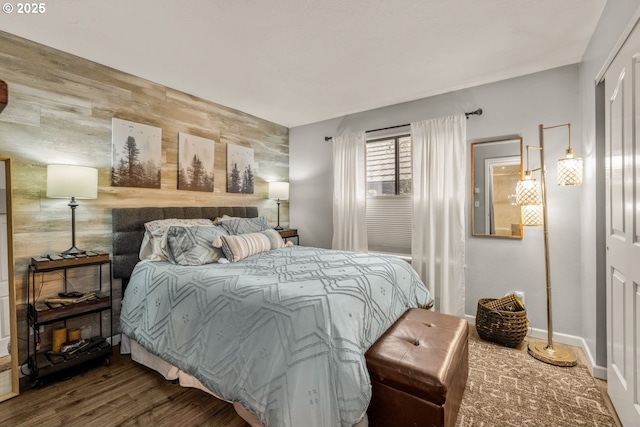 bedroom with wood-type flooring and wooden walls