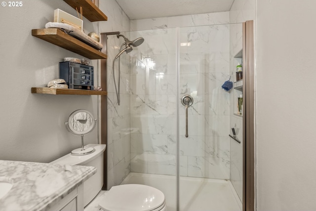 bathroom featuring toilet, vanity, and walk in shower