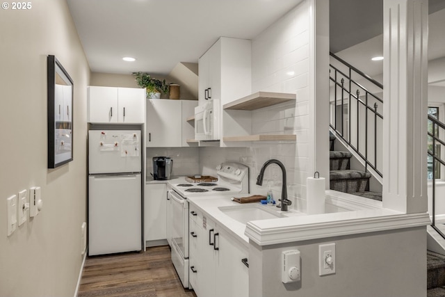 kitchen featuring tasteful backsplash, white appliances, sink, dark hardwood / wood-style floors, and white cabinetry