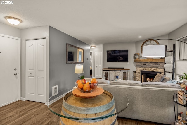 living room with a fireplace and hardwood / wood-style flooring