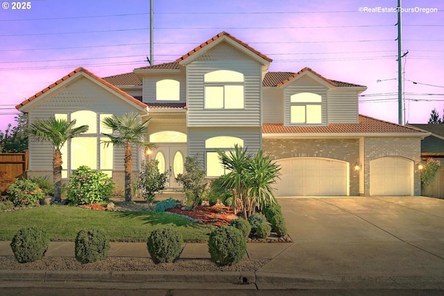 mediterranean / spanish-style house with a garage