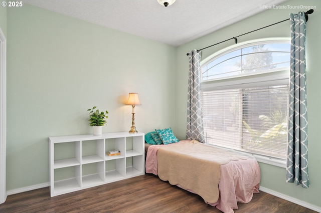 bedroom featuring dark wood-type flooring