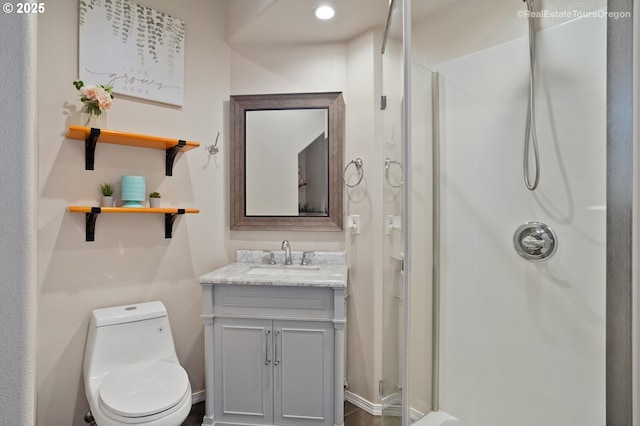 bathroom with vanity, toilet, and walk in shower