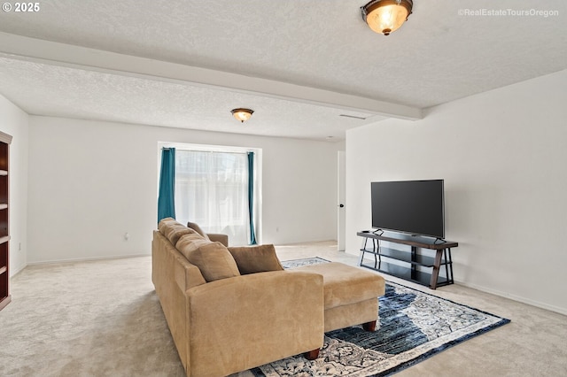 carpeted living room with beam ceiling and a textured ceiling